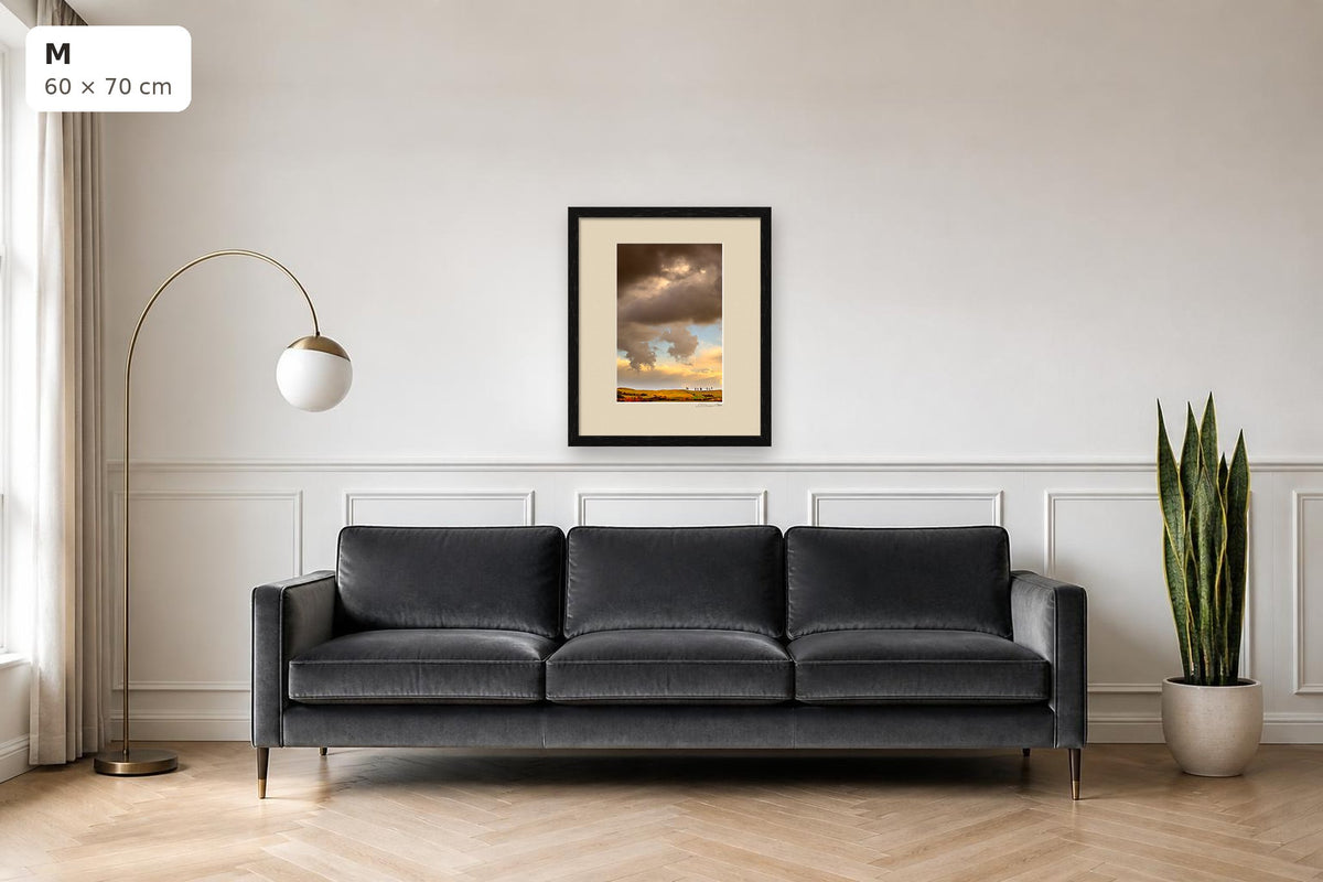 Golden Hills – fine art print by Duccio Nacci, size M with thin black frame shown above a sofa