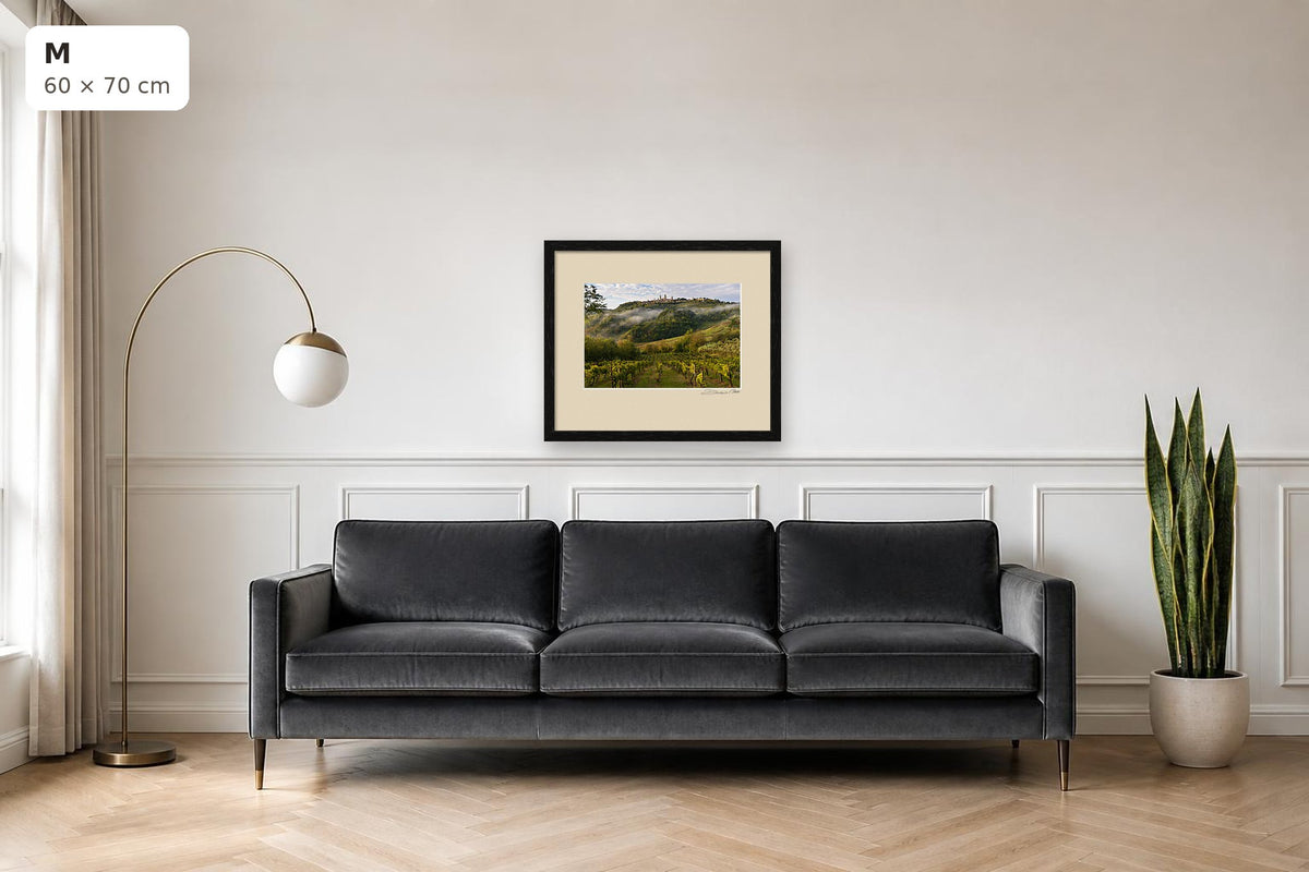 San Gimignano Awakening – fine art print by Duccio Nacci, size M with thin black frame shown above a sofa