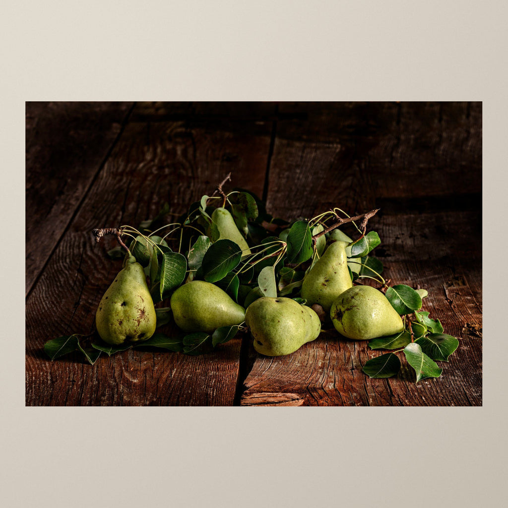 Silence of the Pear – Green pears on a bed of leaves against aged wood – photograph by Duccio Nacci