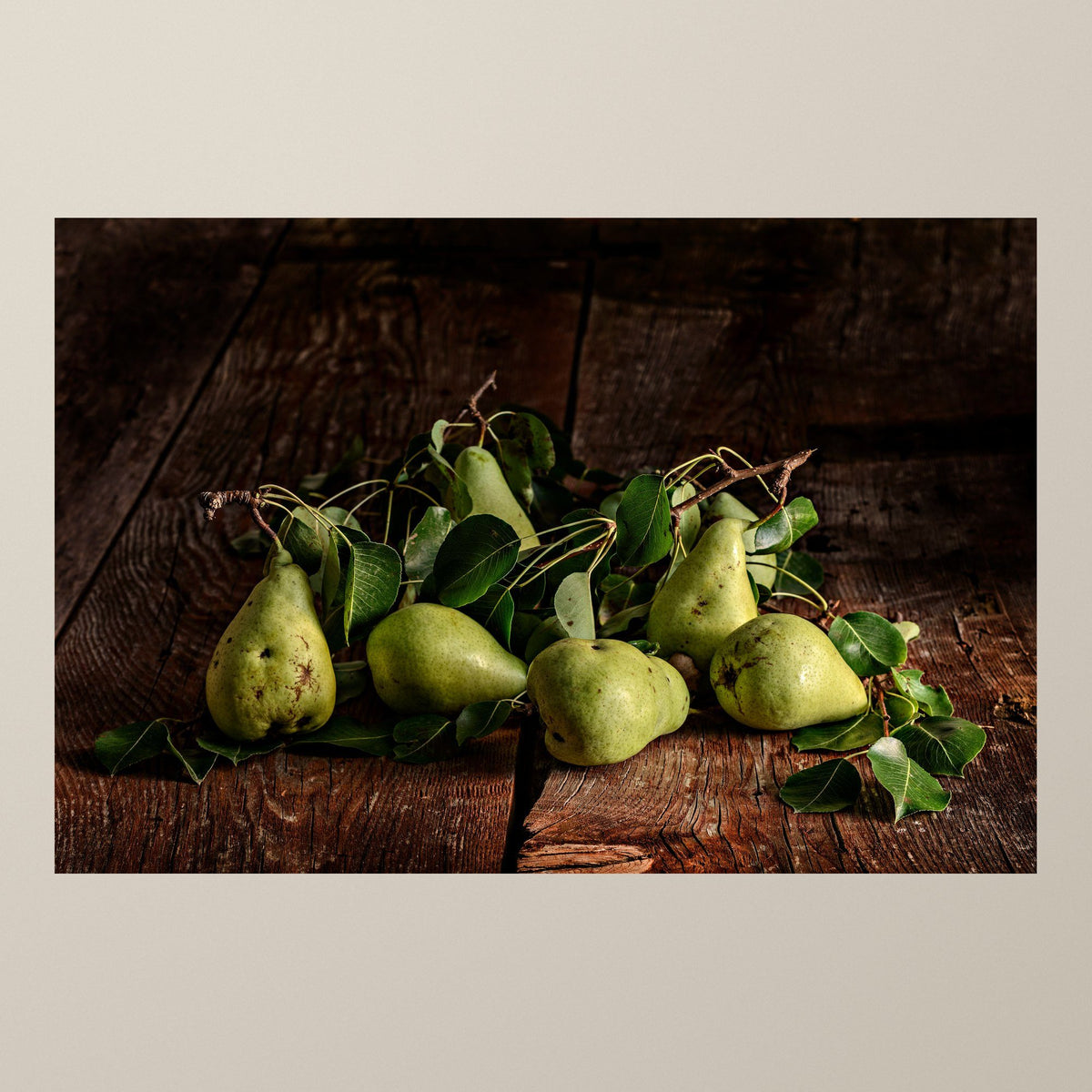 Silence of the Pear – Green pears on a bed of leaves against aged wood – photograph by Duccio Nacci