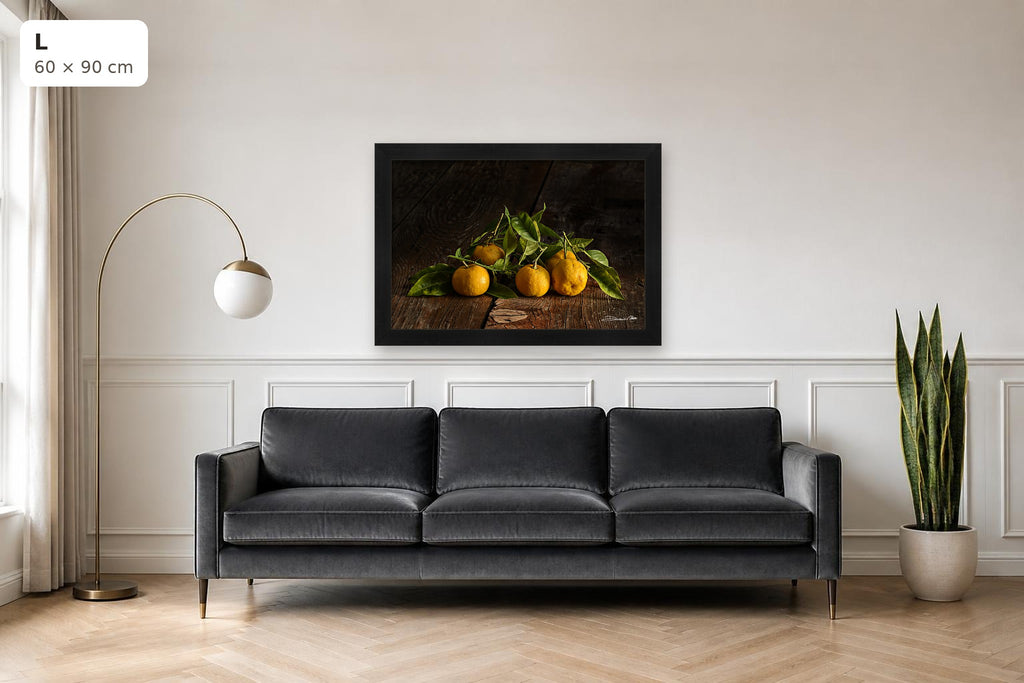Tangerines – fine art print by Duccio Nacci, size L shown above a sofa