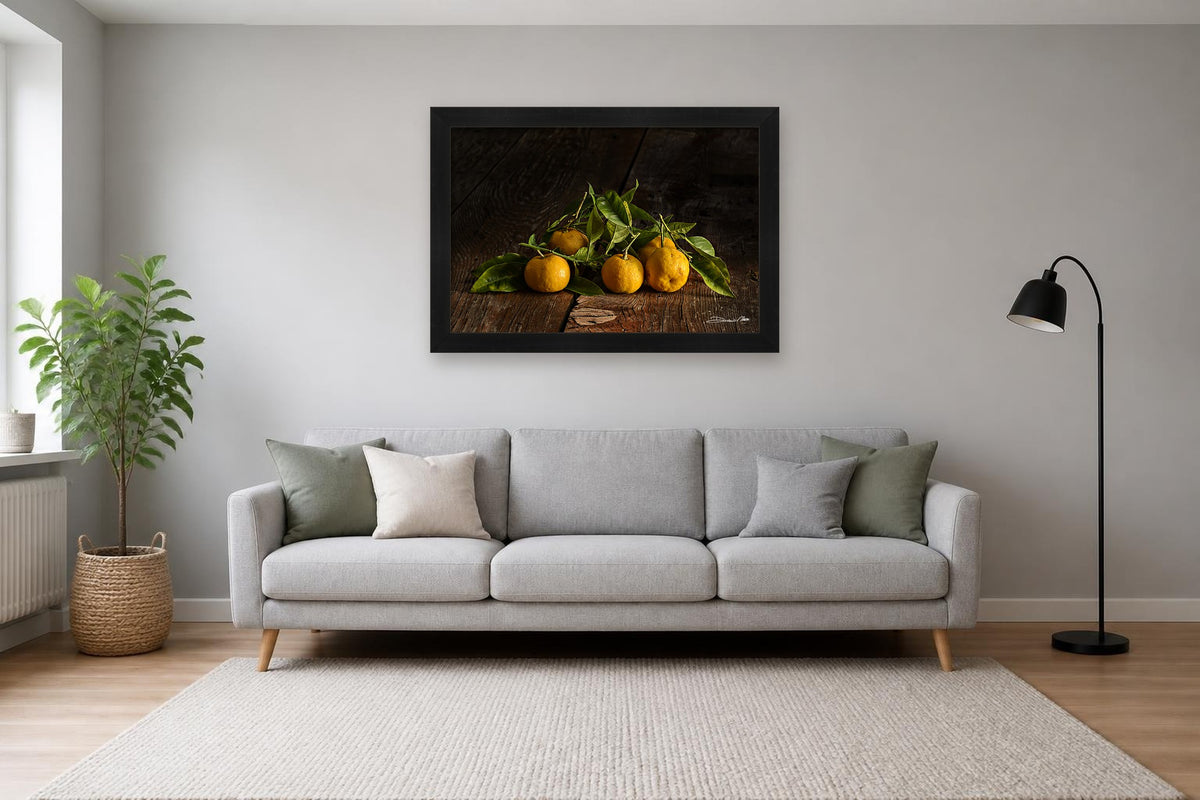 Tangerines – fine art print by Duccio Nacci, size L with black frame in a living room