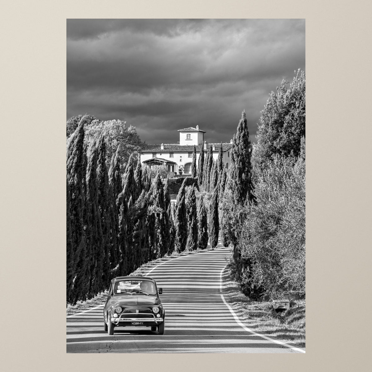 The Cypress Road – A Fiat 500 drives down a Tuscan road lined with tall cypresses – photograph by Duccio Nacci