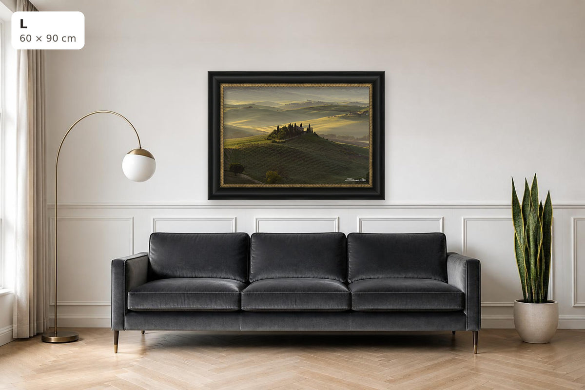 The Suspended Landscape – fine art print by Duccio Nacci, size L with black and gold frame shown above a sofa
