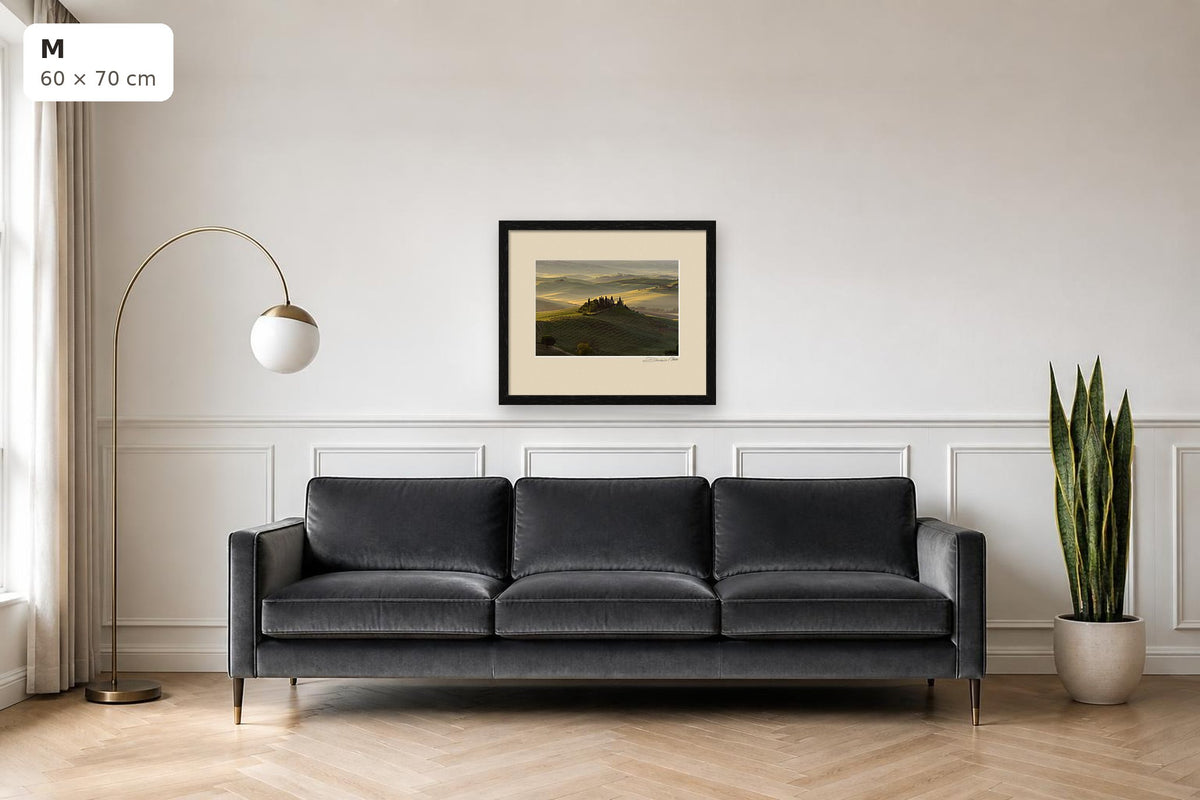 The Suspended Landscape – fine art print by Duccio Nacci, size M with thin black frame shown above a sofa