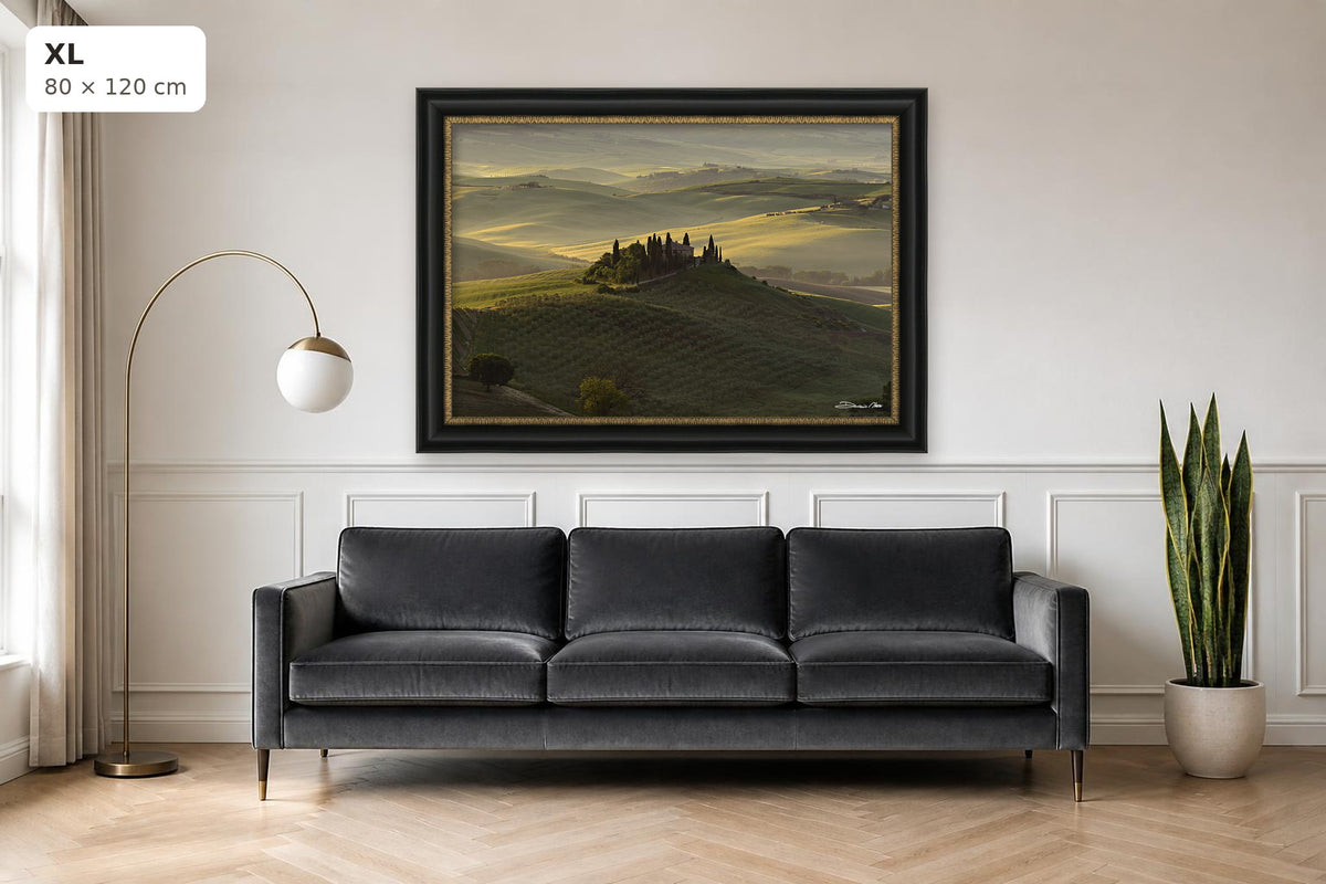 The Suspended Landscape – fine art print by Duccio Nacci, size XL with black and gold frame shown above a sofa