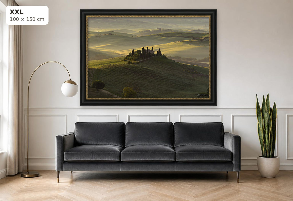 The Suspended Landscape – fine art print by Duccio Nacci, size XXL with black and gold frame shown above a sofa