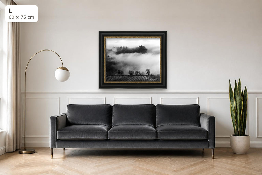 Whispers in the Mist – fine art print by Duccio Nacci, size L with black and gold frame shown above a sofa