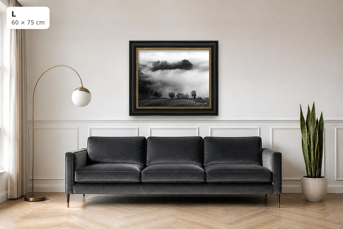 Whispers in the Mist – fine art print by Duccio Nacci, size L with black and gold frame shown above a sofa