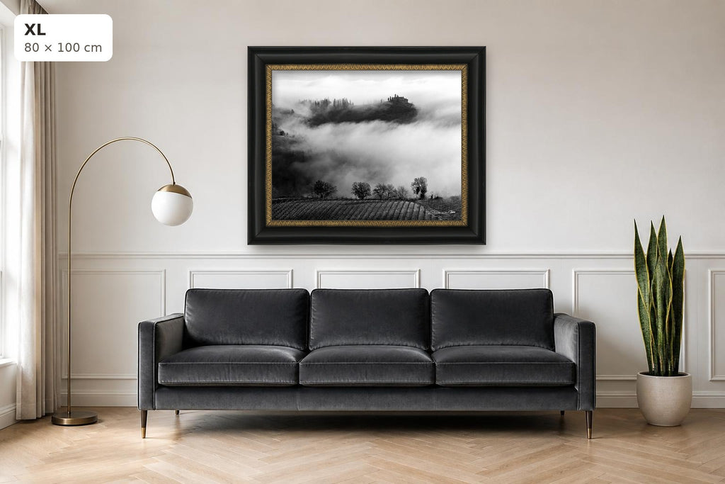 Whispers in the Mist – fine art print by Duccio Nacci, size XL with black and gold frame shown above a sofa