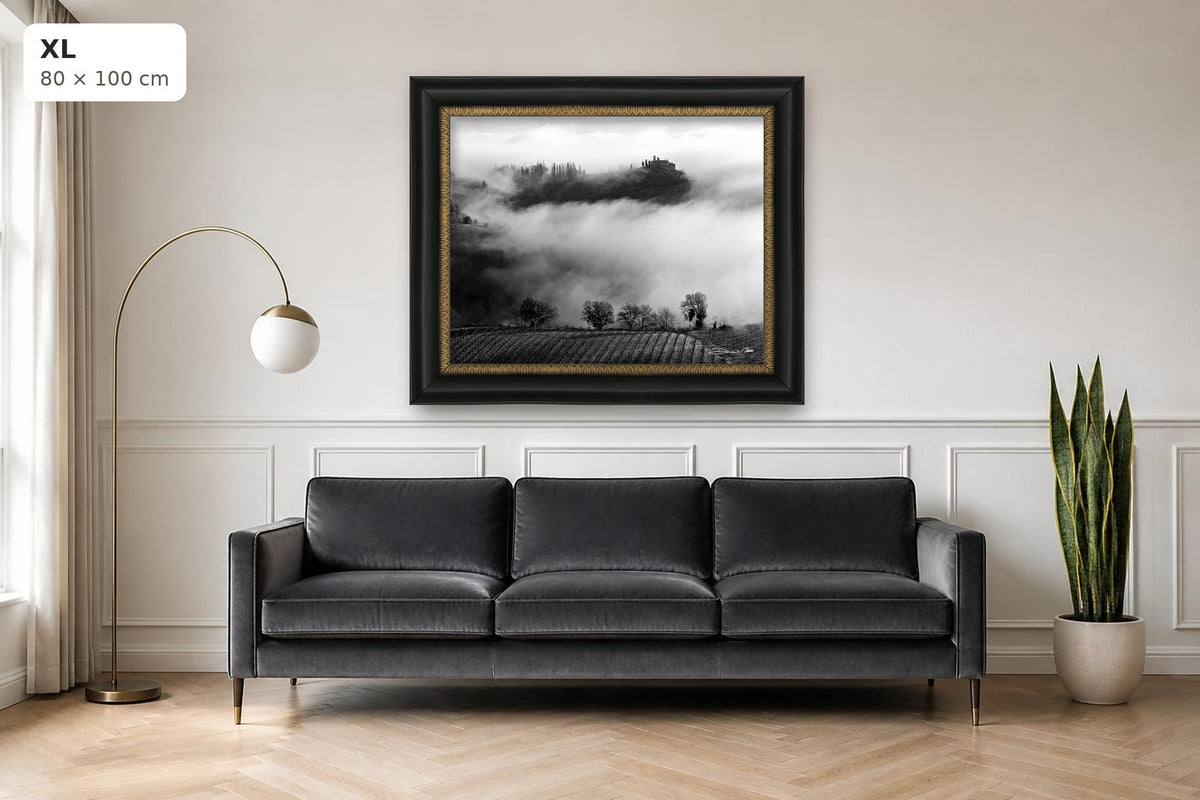 Whispers in the Mist – fine art print by Duccio Nacci, size XL with black and gold frame shown above a sofa