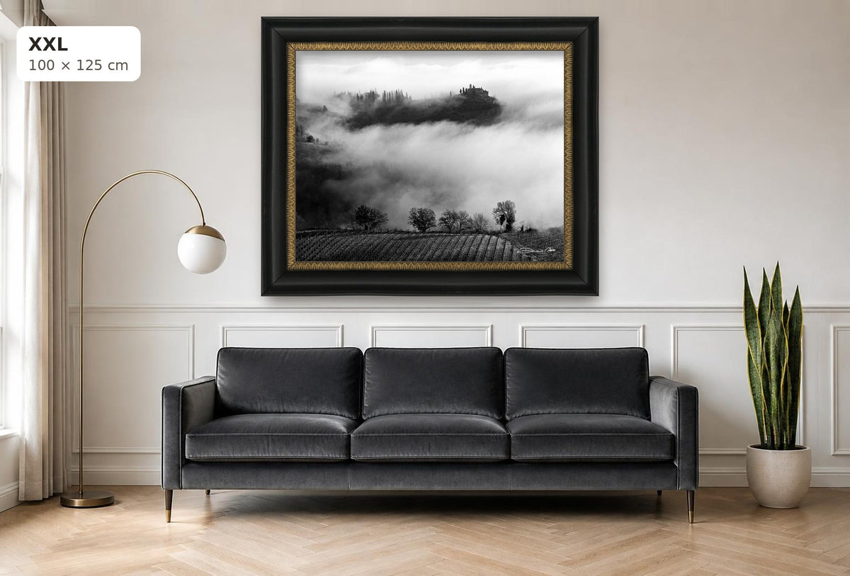 Whispers in the Mist – fine art print by Duccio Nacci, size XXL with black and gold frame shown above a sofa